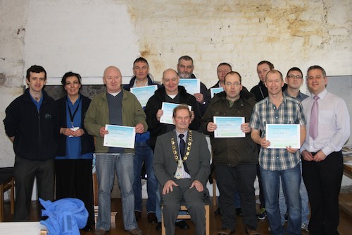 Members of AMH New Horizons receive their certificates from John McArdle, Mayor.